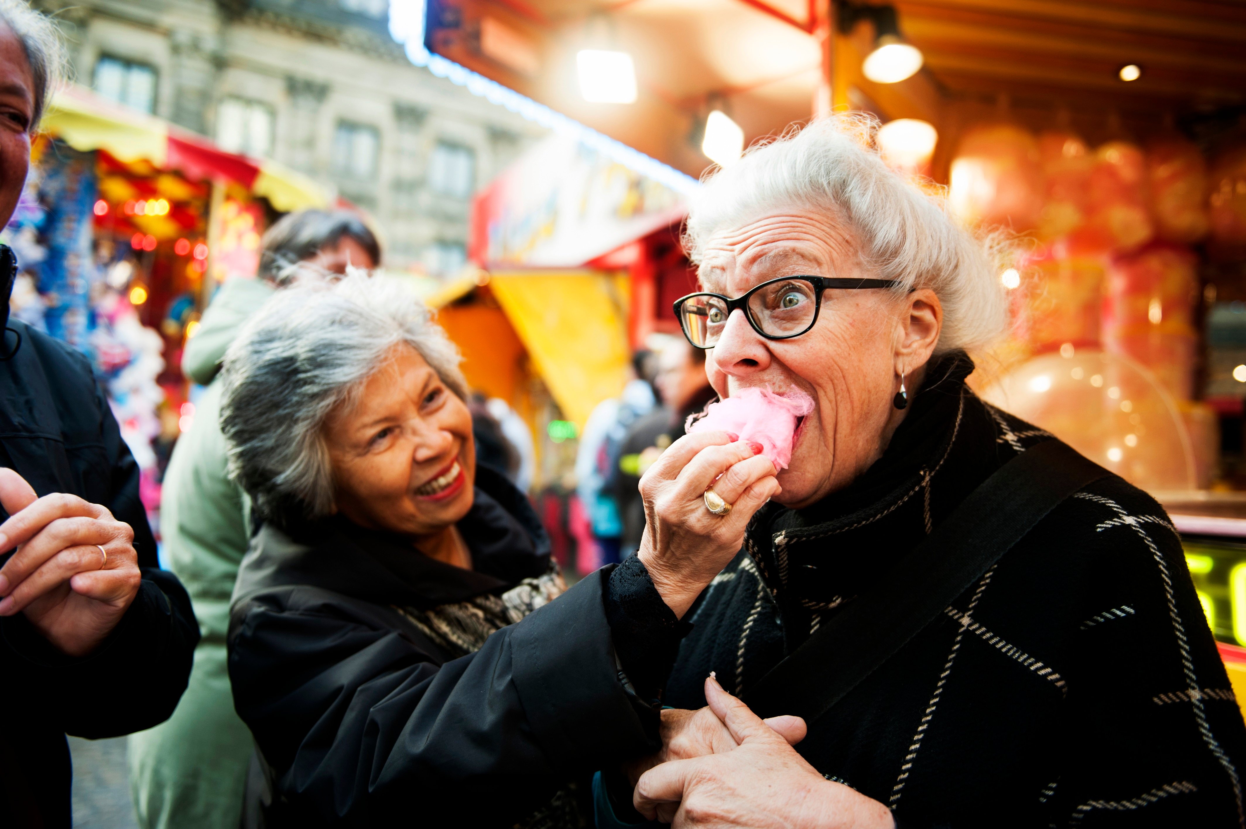 a person eating a pink pastry