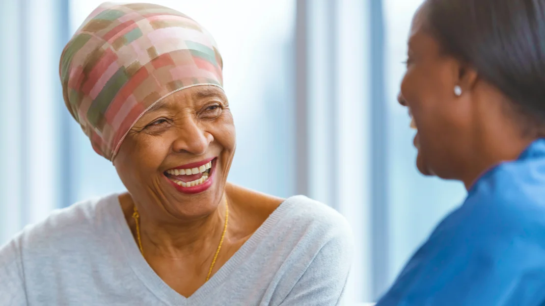 a woman smiling next to another woman